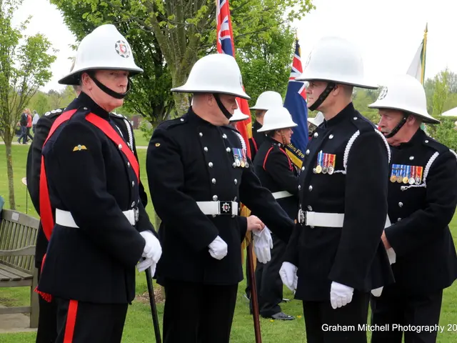 In the foreground I can see a group of people are standing on grass are wearing helmets on their...