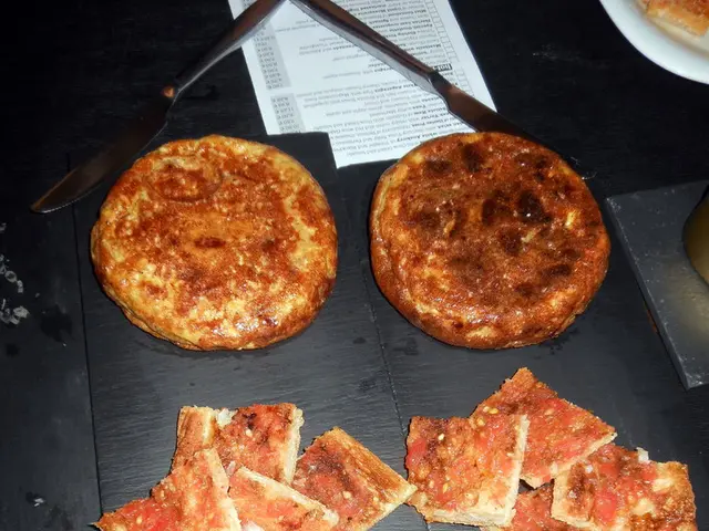 There is a baked food, spoons and a paper kept on the surface as we can see in the middle of this...