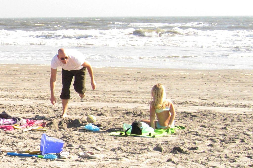 Man in custody after posting lewd images online, authorities claim he violated privacy rights and child protection laws. Dog enjoys a swim while clenching a round, green plaything in its jaws.